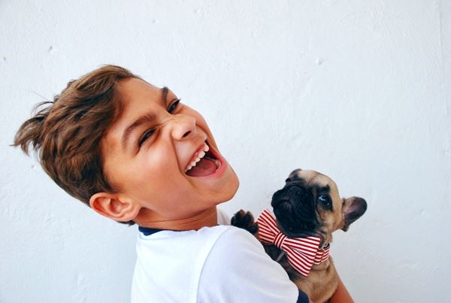Child holding a puppy