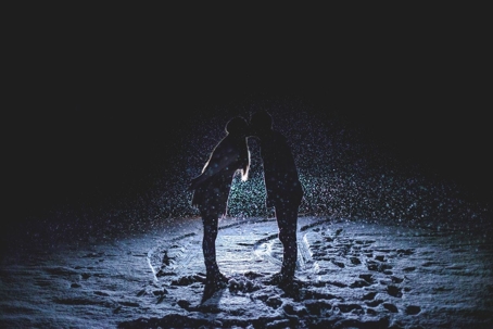 Two people kissing in the snow